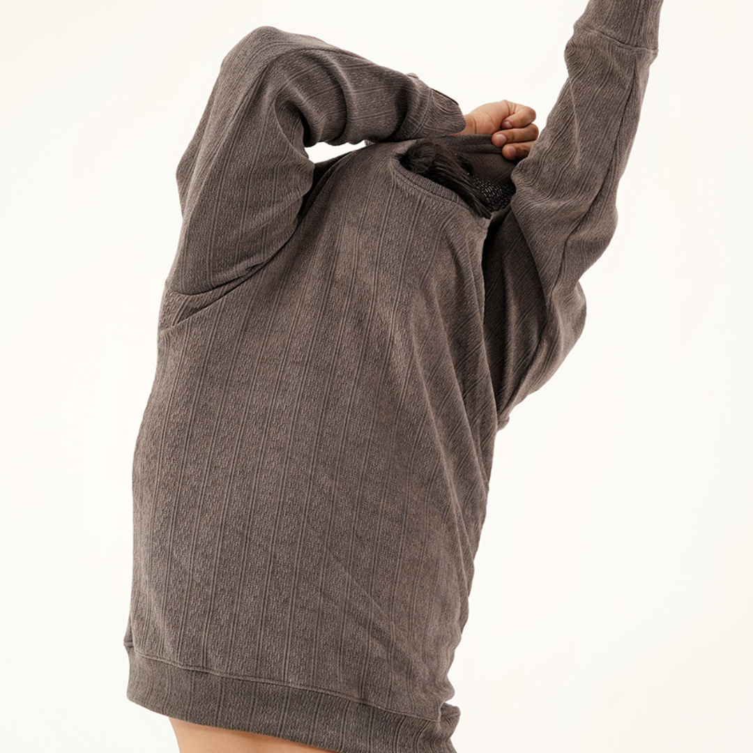 Model wearing a stylish sweater from the Daily Luxe Drops collection, showcasing effortless elegance.