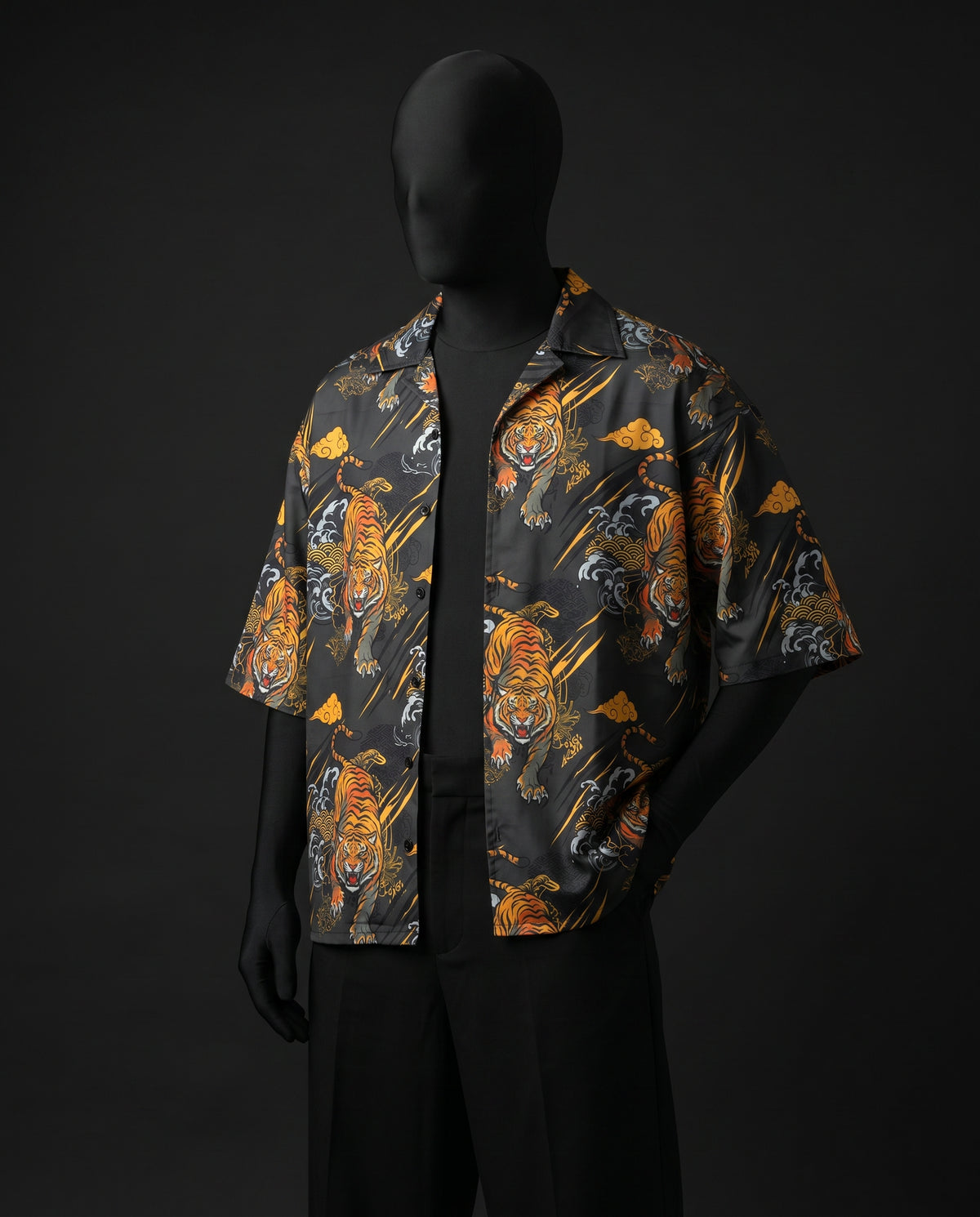 Three-quarter view of open tiger print Cuban shirt worn over black tee on mannequin