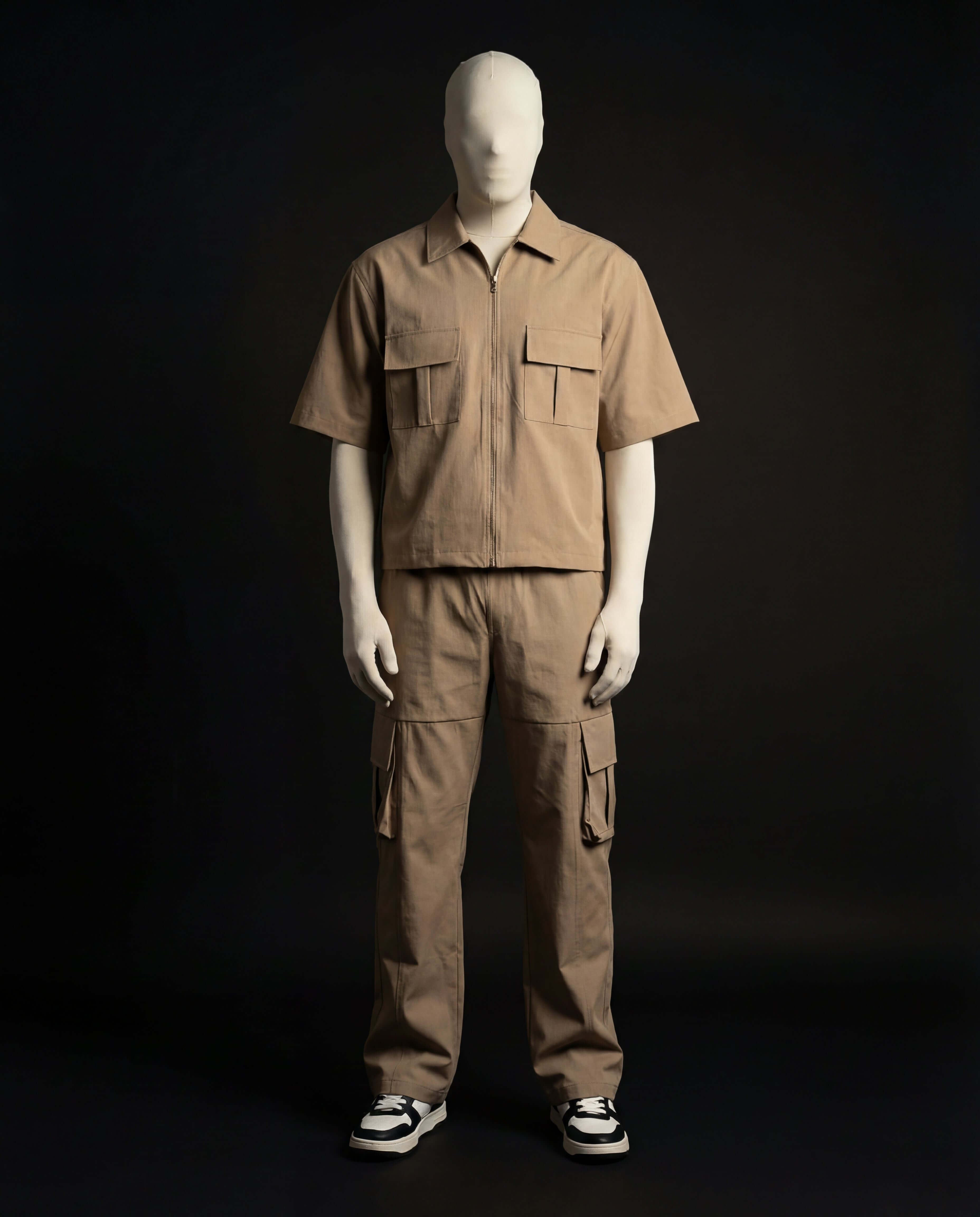 Tan Utility Zip Co-ord showcased on a mannequin against a dark background, highlighting its tactical design and aesthetics.