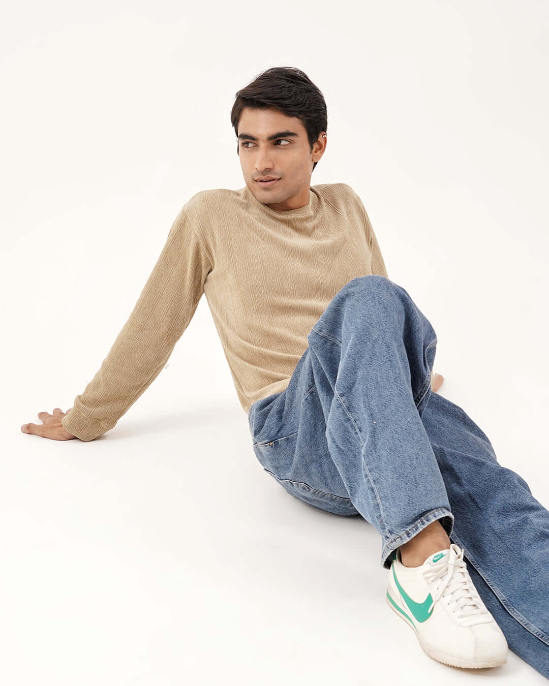 Daily Luxe Jacquard Sweatshirt on model in desert sand color, styled with casual jeans and sneakers.