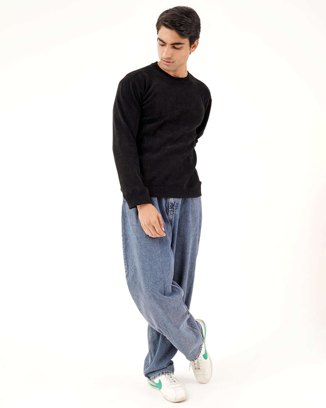 Model wearing Daily Luxe Jacquard Sweatshirt in Midnight Black with relaxed denim jeans.