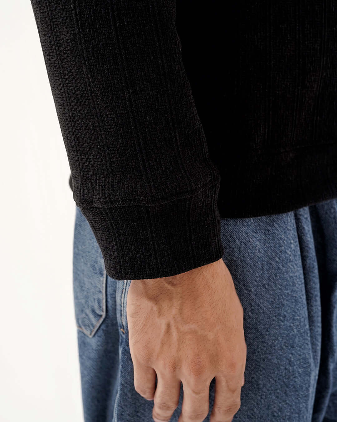 Detail of the sleeve and cuff of the Daily Luxe Jacquard Sweatshirt in Midnight Black, showcasing its premium texture.