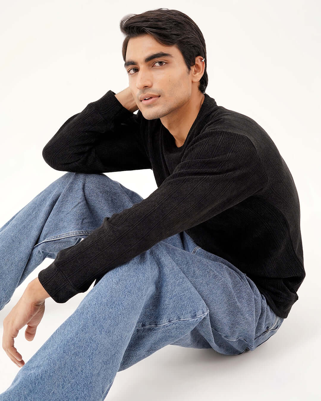 Model wearing Daily Luxe Jacquard Sweatshirt in Midnight Black, styled with relaxed denim jeans.