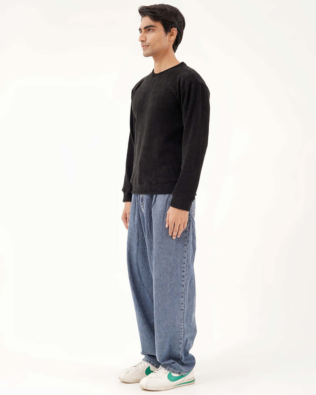 Daily Luxe Jacquard Sweatshirt in Midnight Black worn with relaxed denim trousers on a male model.