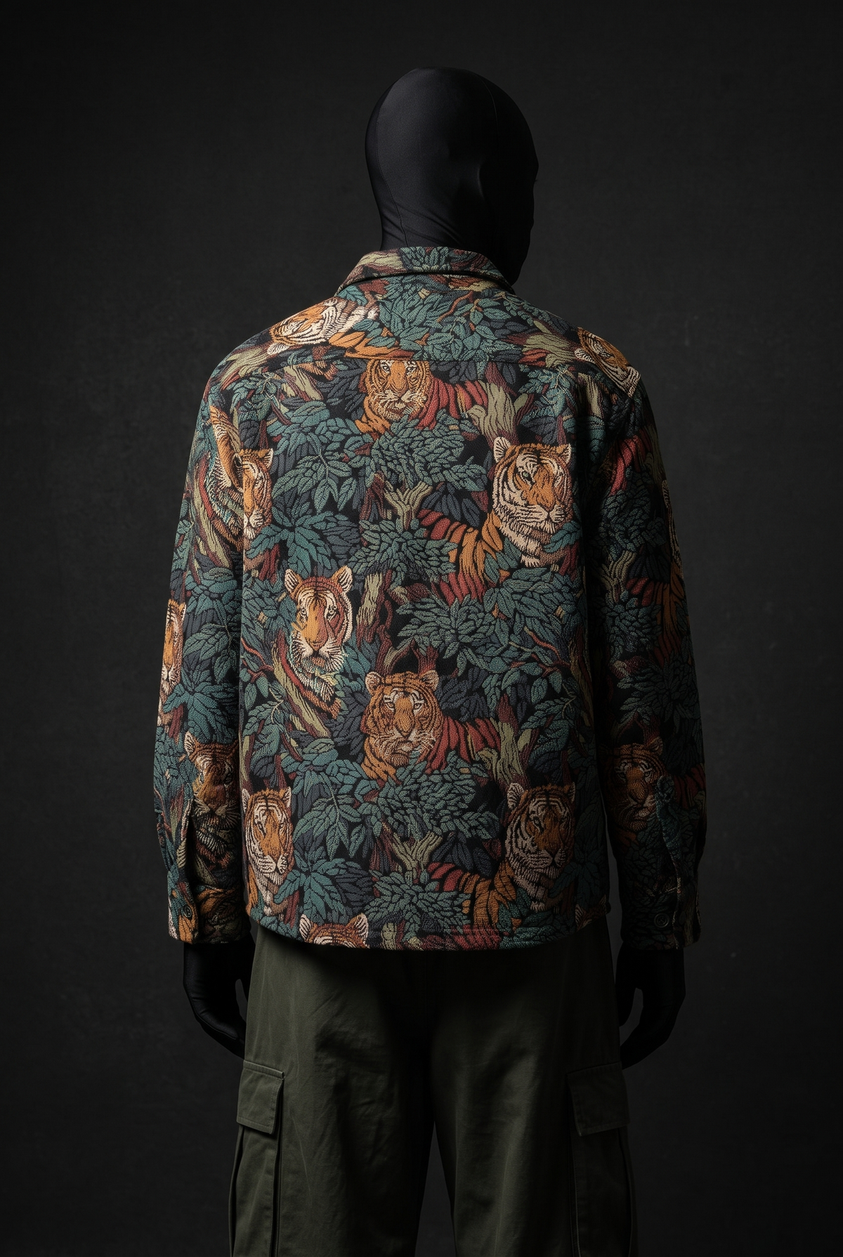 Back view of tiger-and-foliage print overshirt in teal, orange and black, worn with olive cargo pants