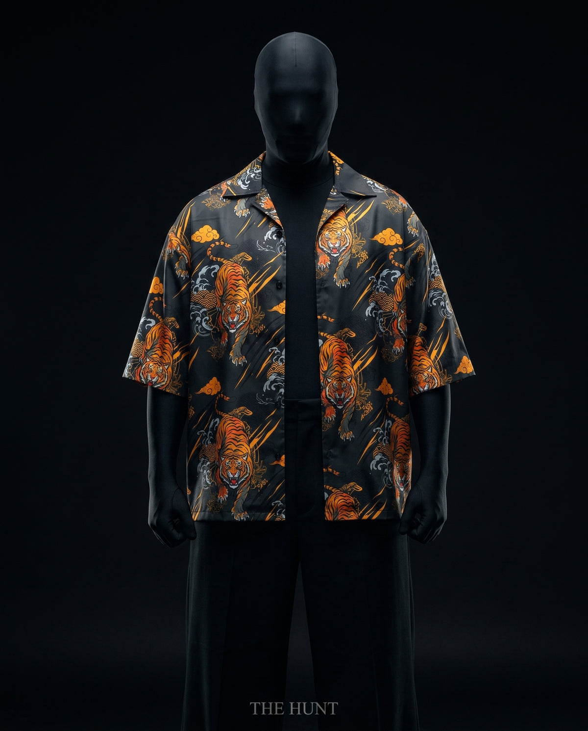 Front view of open tiger print boxy shirt over black tee, with 'The Hunt' text below