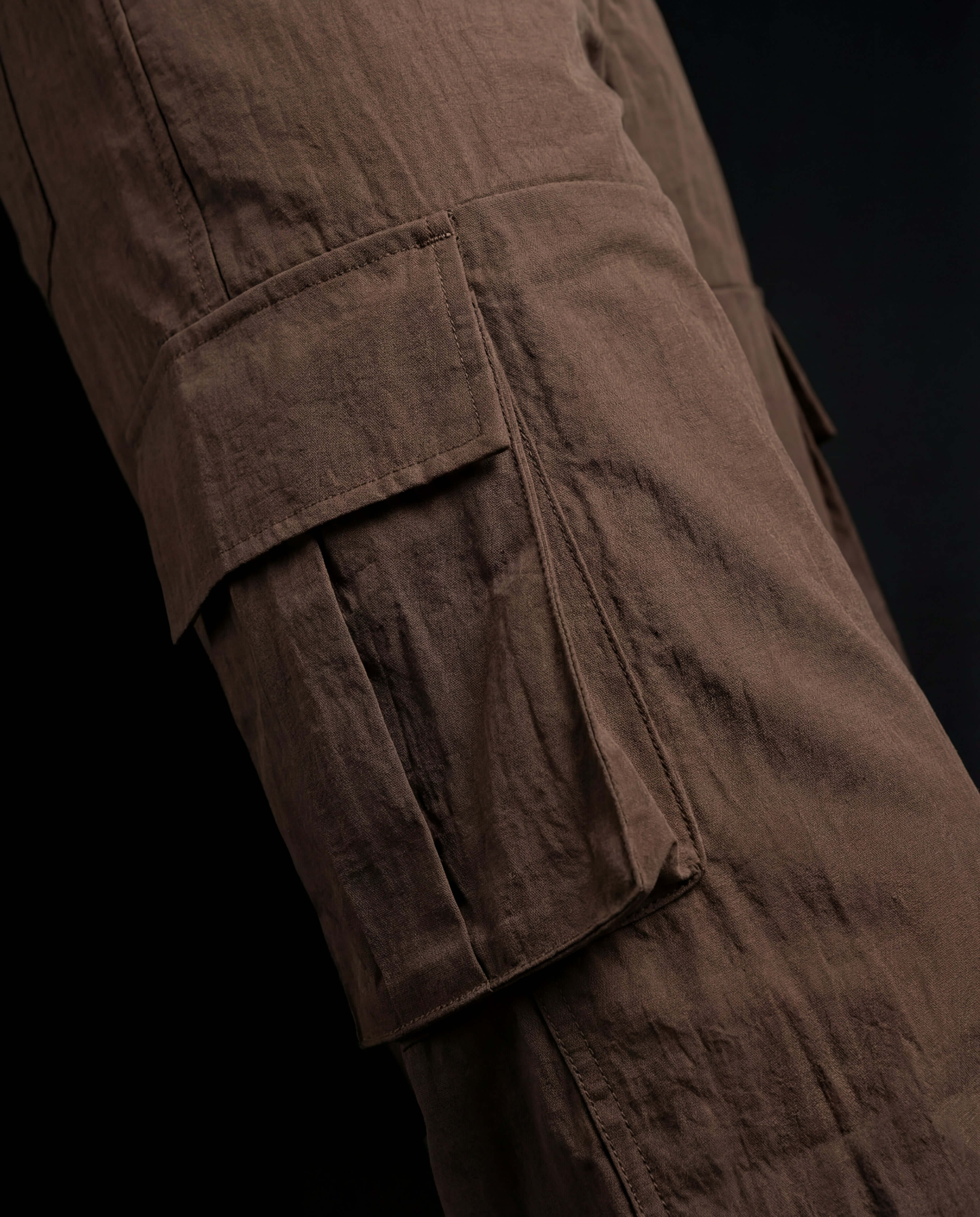 Close-up of Earth Utility Zip Co-ord pants showcasing cargo pockets and textured fabric in earthy brown color.