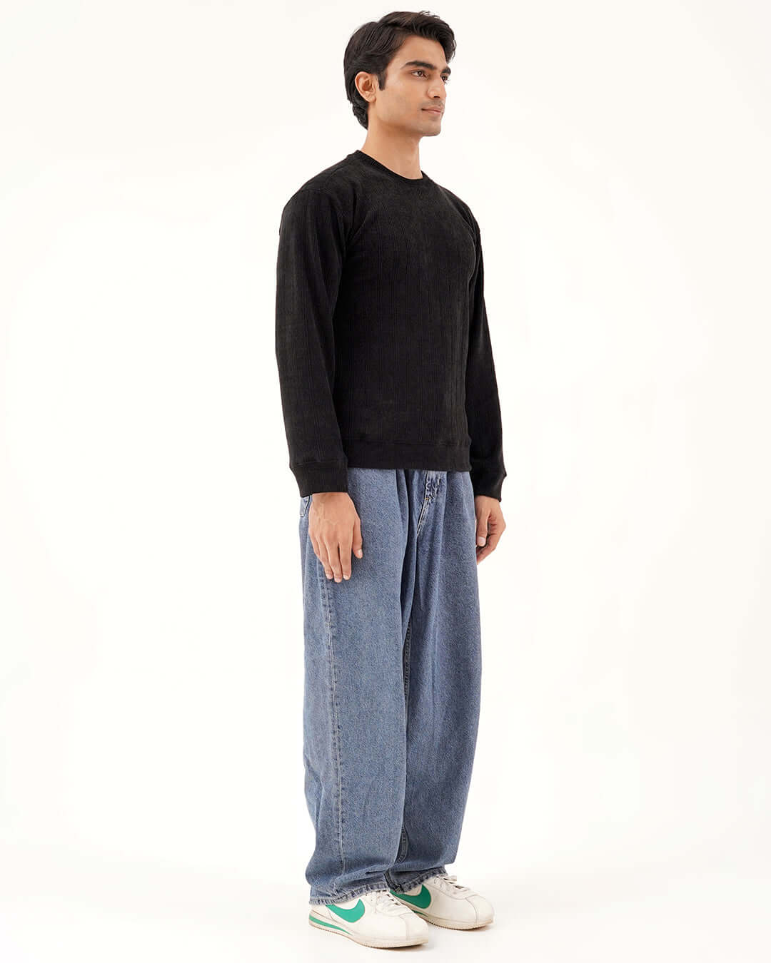 Model showcasing the Daily Luxe Jacquard Sweatshirt in Midnight Black paired with relaxed denim jeans.