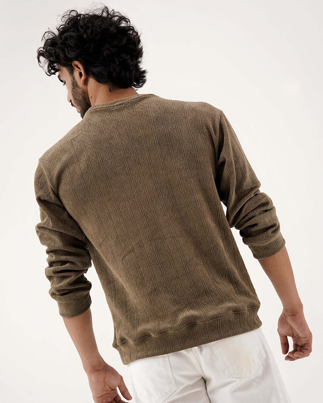 Man wearing a Daily Luxe Jacquard Sweatshirt – Olive Grove, showcasing textured design from the back.
