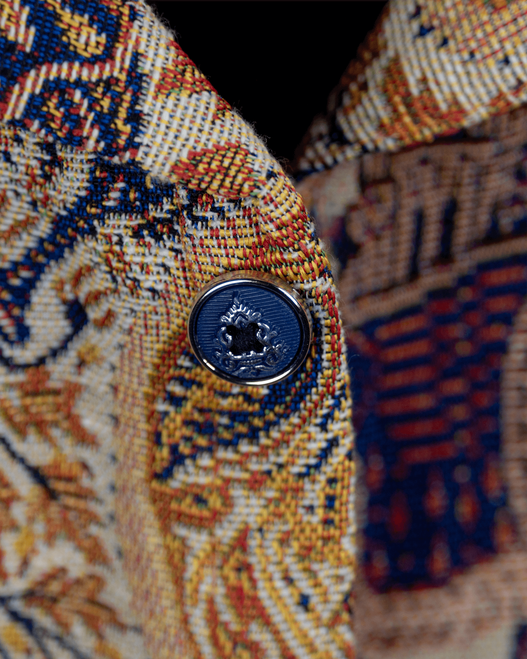 Close-up of the Elephant Memoir Shacket showing premium jacquard fabric and decorative button detail.