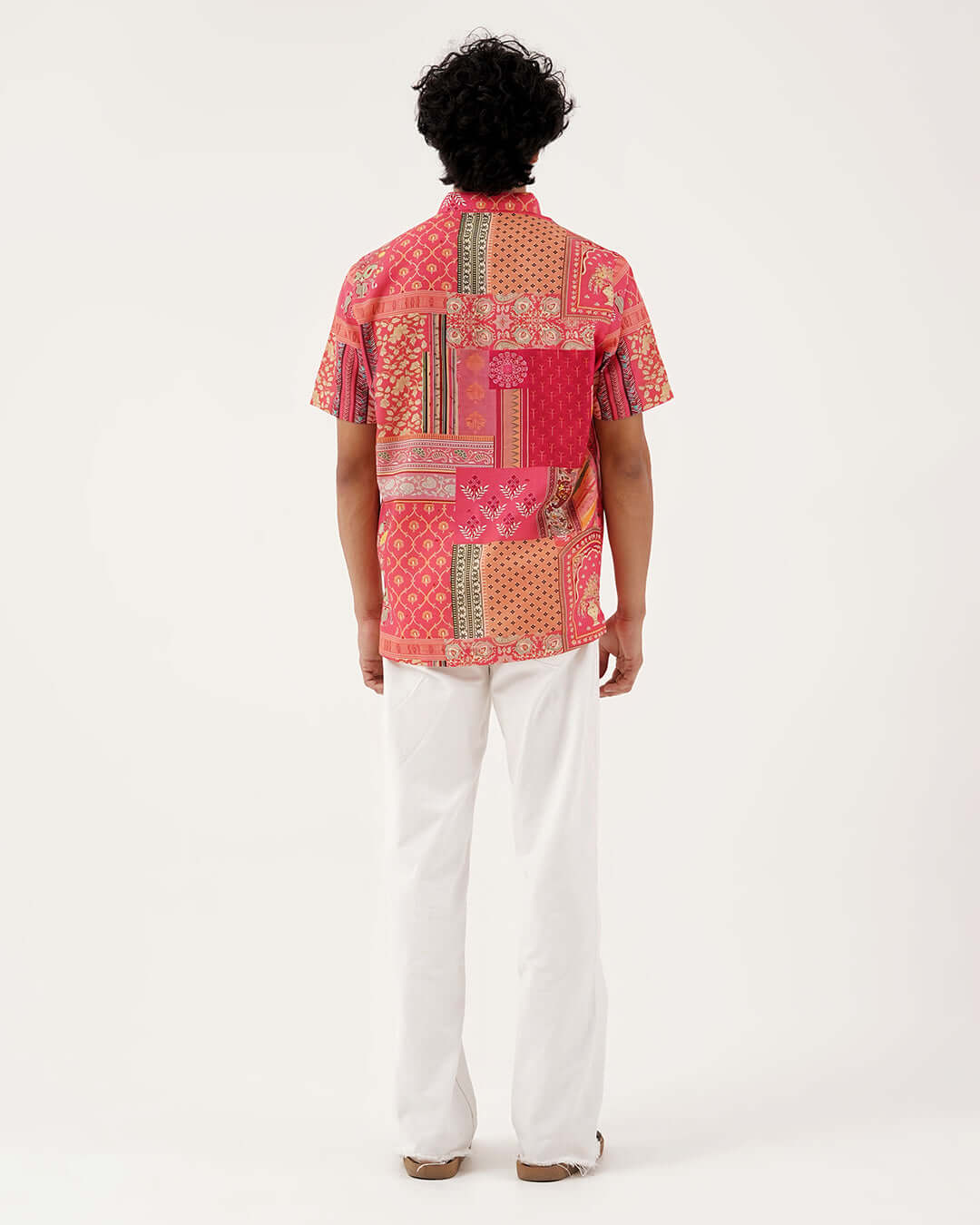 Back view of a man wearing the Festive Grace Short Kurta, featuring vibrant patterns and elegant design.