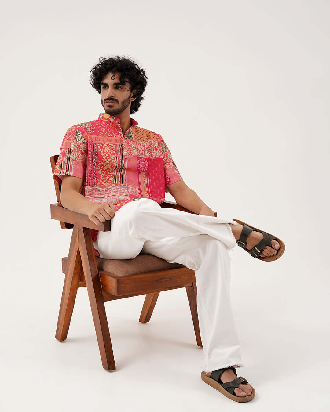 Model showcasing the Festive Grace Short Kurta, a vibrant ethnic wear for men, paired with white pants.