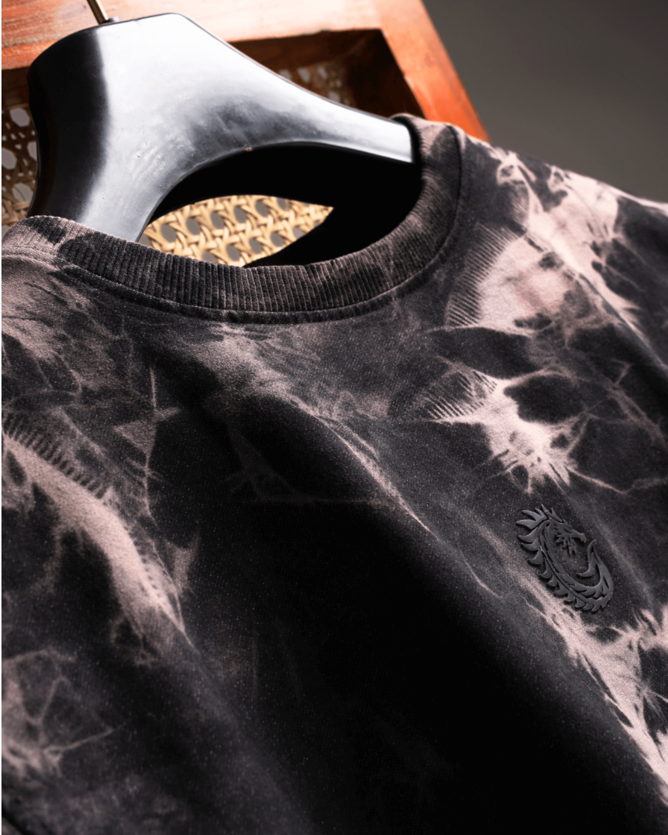 Close-up of the Electric Ash Hand Washed Tee featuring a distressed pattern and logo detail.