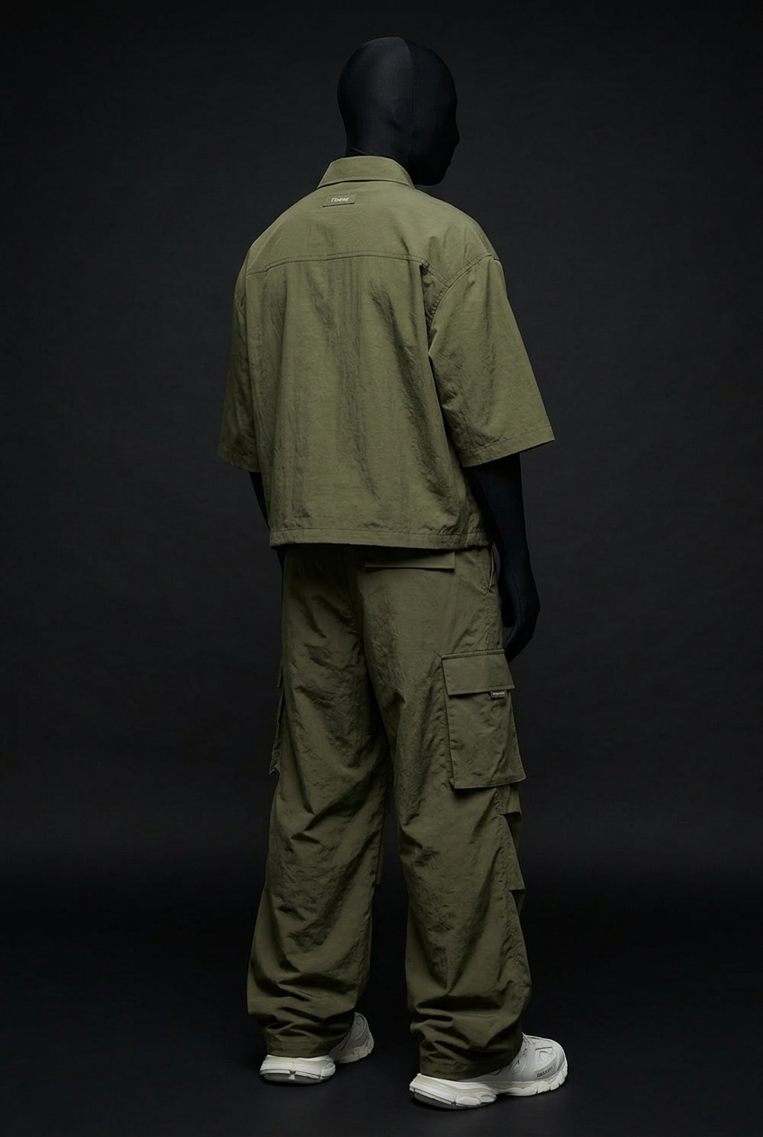 Rear three-quarter view of olive cropped shirt and cargo pants with large side pocket