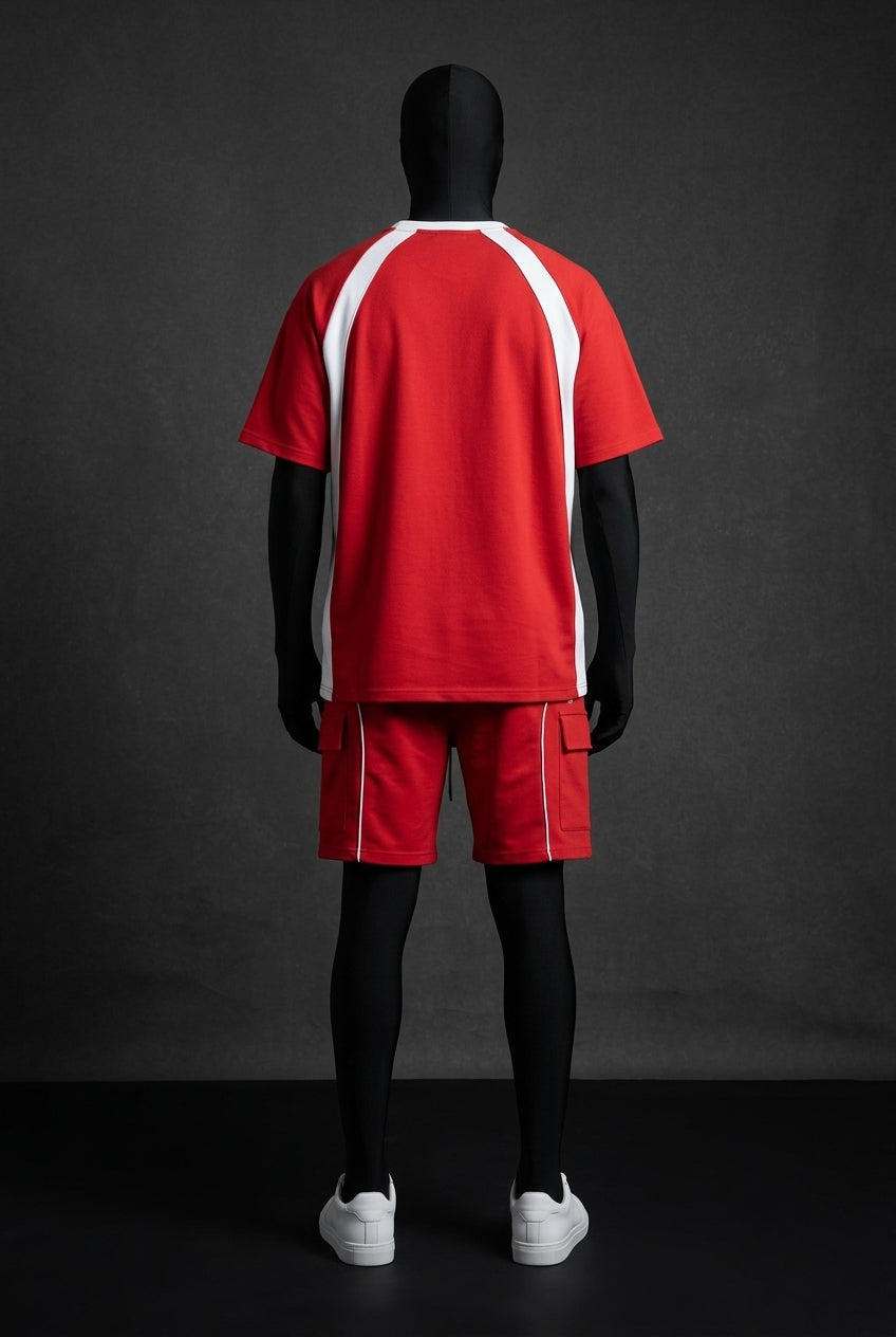 Back view of red raglan tee with white side panels and red cargo shorts with white piping
