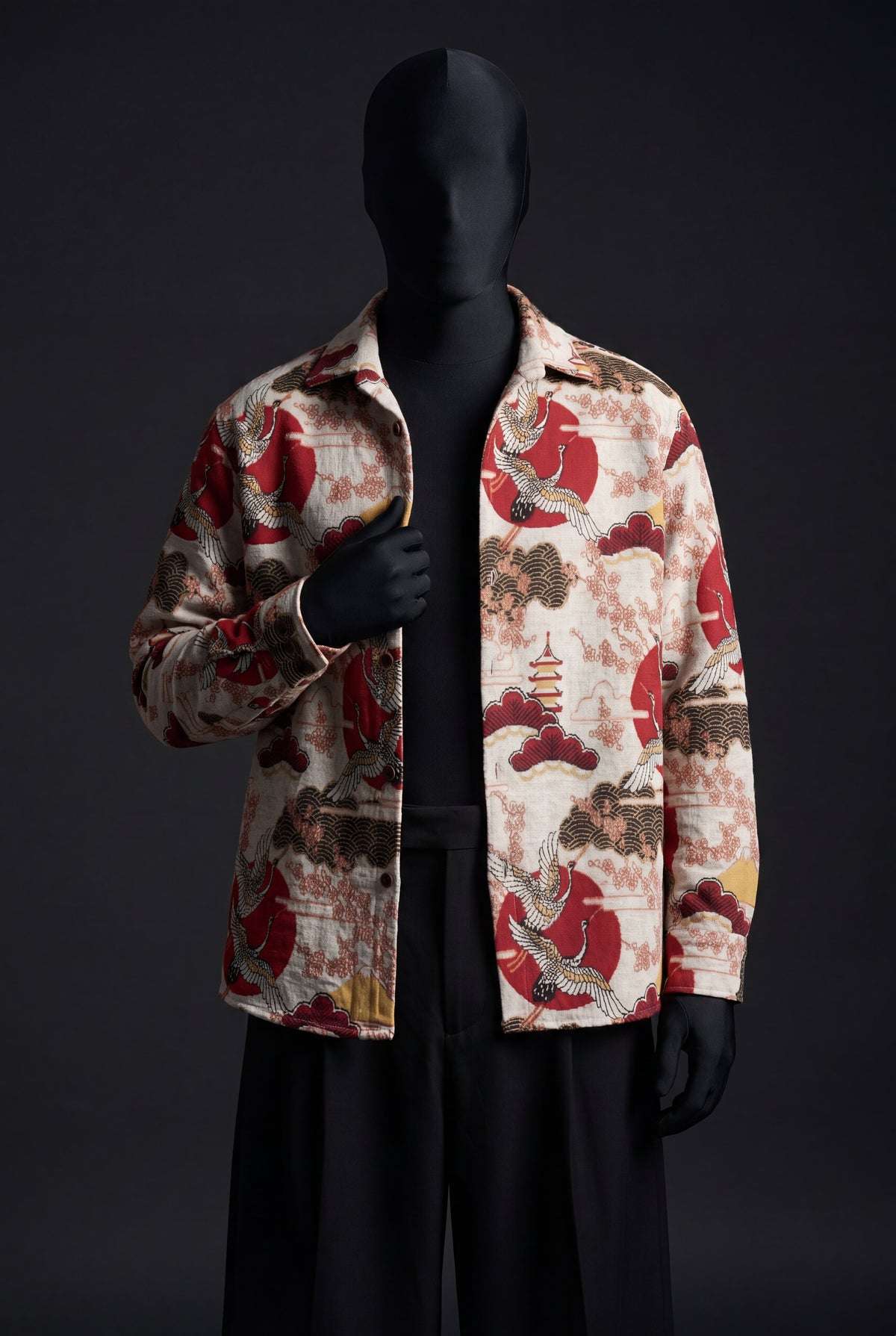 Cream overshirt with red suns, cranes, pagoda and wave print, worn open on a black mannequin, front view