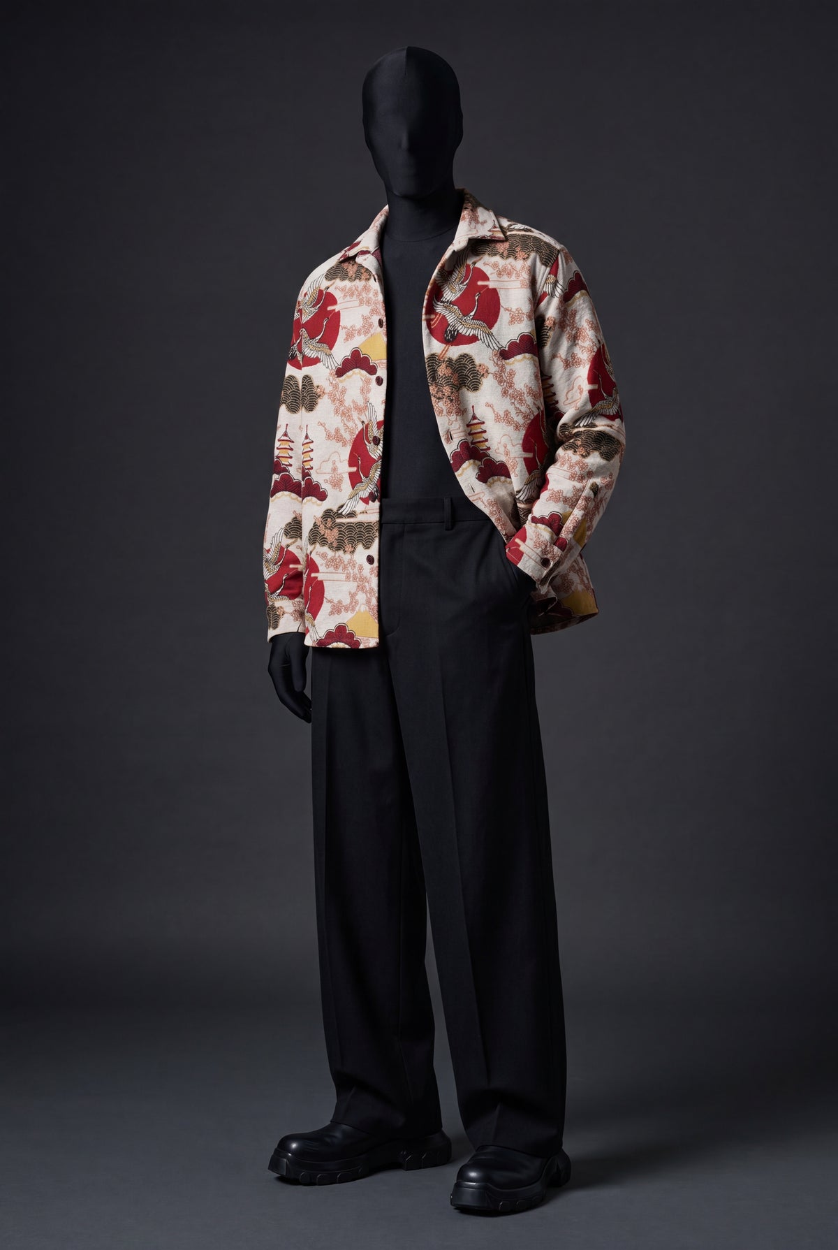Cream overshirt with red suns, cranes, pagodas and clouds print, worn open on a mannequin with black trousers, front view